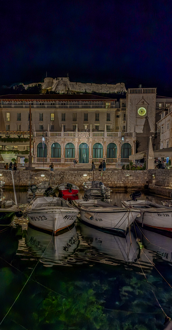 Boats docked at night in Hvar.