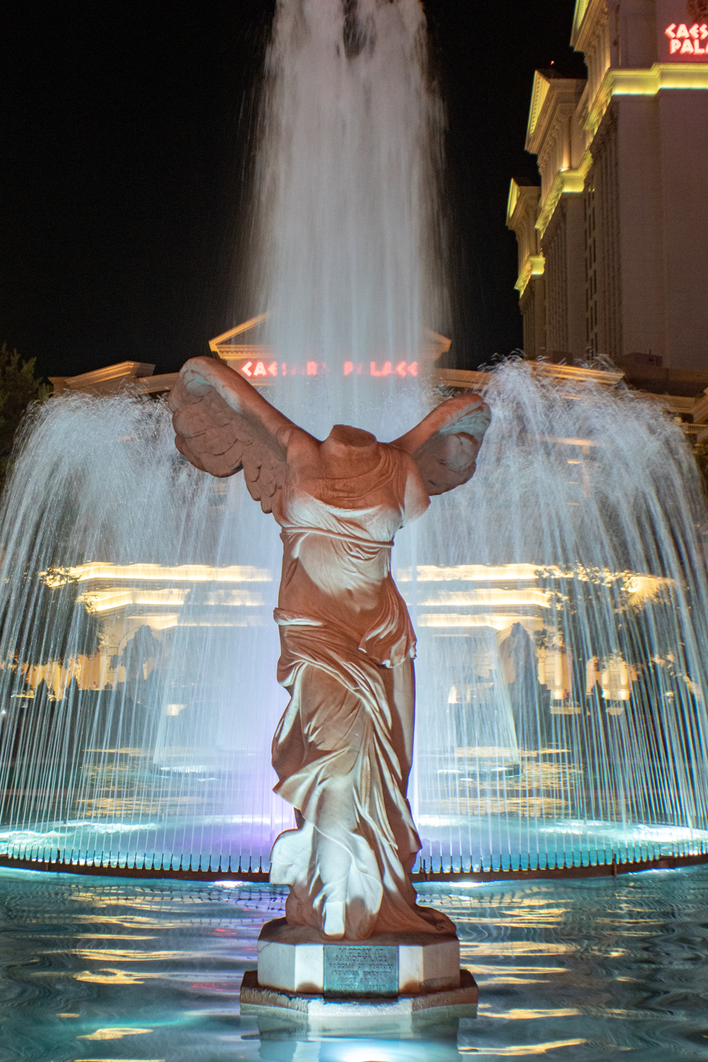 A statue of Nike of Samothrace at night in front of the fountain at Caesar's Palace in Las Vegas, Nevada.