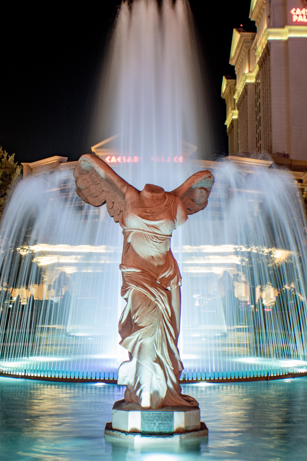 A statue of Nike of Samothrace at night in front of the fountain at Caesar's Palace in Las Vegas, Nevada.