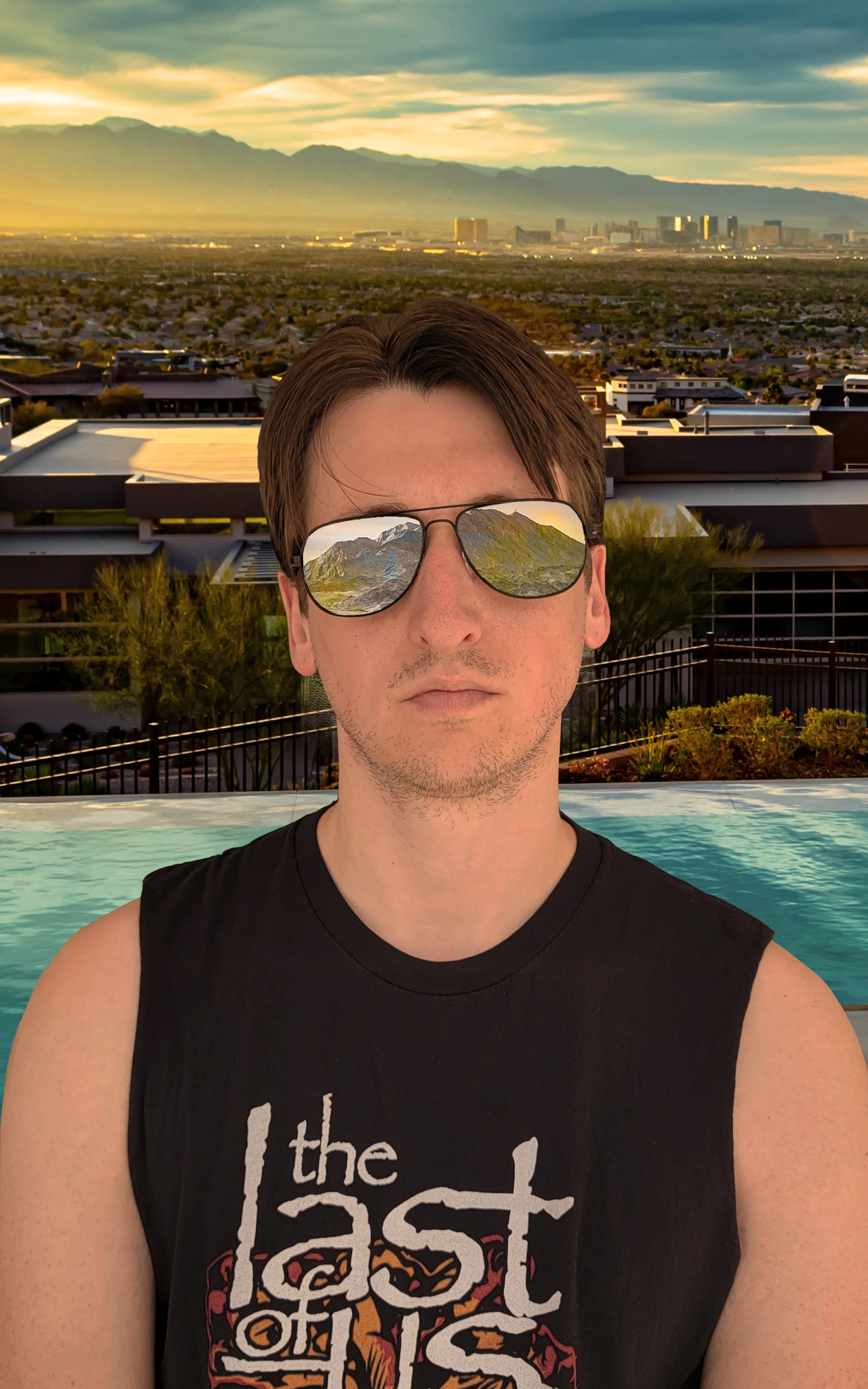 Portrait of a man with a backdrop of the Las Vegas valley during the golden hour, and desert mountains reflected in his sunglasses